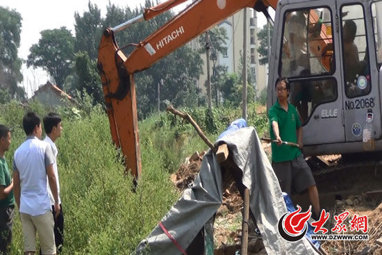 陳寶成手持自制刀斧守在挖掘機(jī)旁阻止便衣民警靠前。駕駛室內(nèi)，張朋珂正向受害人郭曉剛身上澆汽油。（視頻截圖）