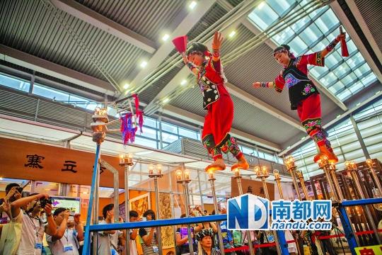2號(hào)展館，苗族姑娘表演踩燈泡絕技《電光玫瑰》，赤腳踩上40瓦的燈泡并做出高難度動(dòng)作。 南都記者 霍健斌 攝