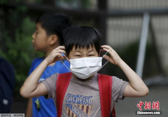 圖為當?shù)貢r間2015年6月8日，韓國未停課的學校，學生課前戴口罩測體溫。