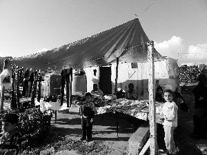 黎巴嫩一敘利亞難民營，難民支起攤鋪賣衣服掙錢。