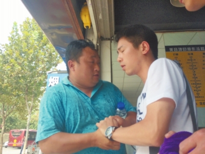 記者正查看照片，突遭藍(lán)衣男強(qiáng)搶手機(jī)。