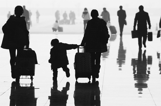 昨日，鄭州東站，一名孩子拉著媽媽和包裹快樂(lè)地奔走在春運(yùn)的途中