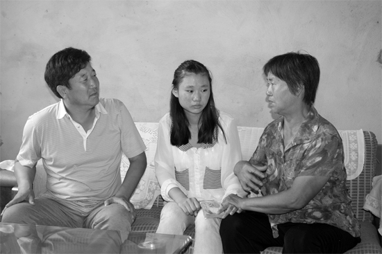 “商丘最美女兒”李丹（中）捐骨髓救母，愛心人士（左）送來1萬元愛心款