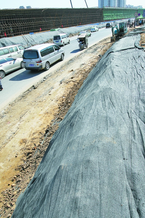 豐樂(lè)路與北三環(huán)交叉口，修路的土被歸置得整整齊齊，并用黑網(wǎng)覆蓋，既保暢通又避免了揚(yáng)塵。